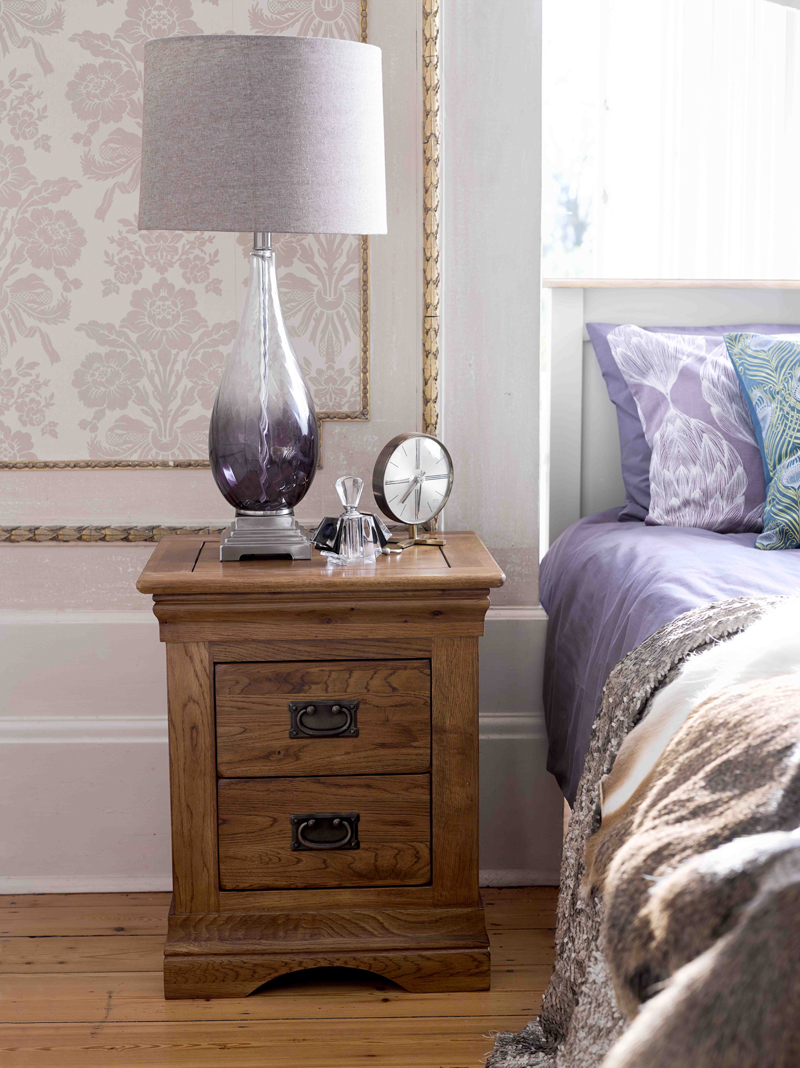 Bedside table with purple lamp