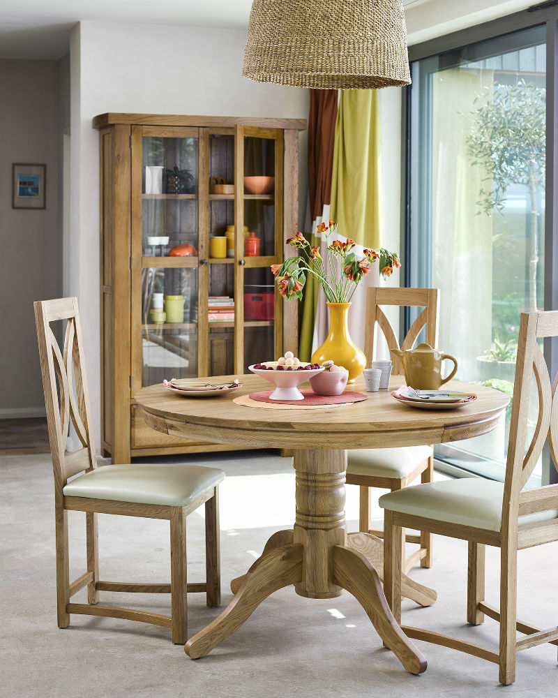 round oak dining table and chairs in rustic dining room