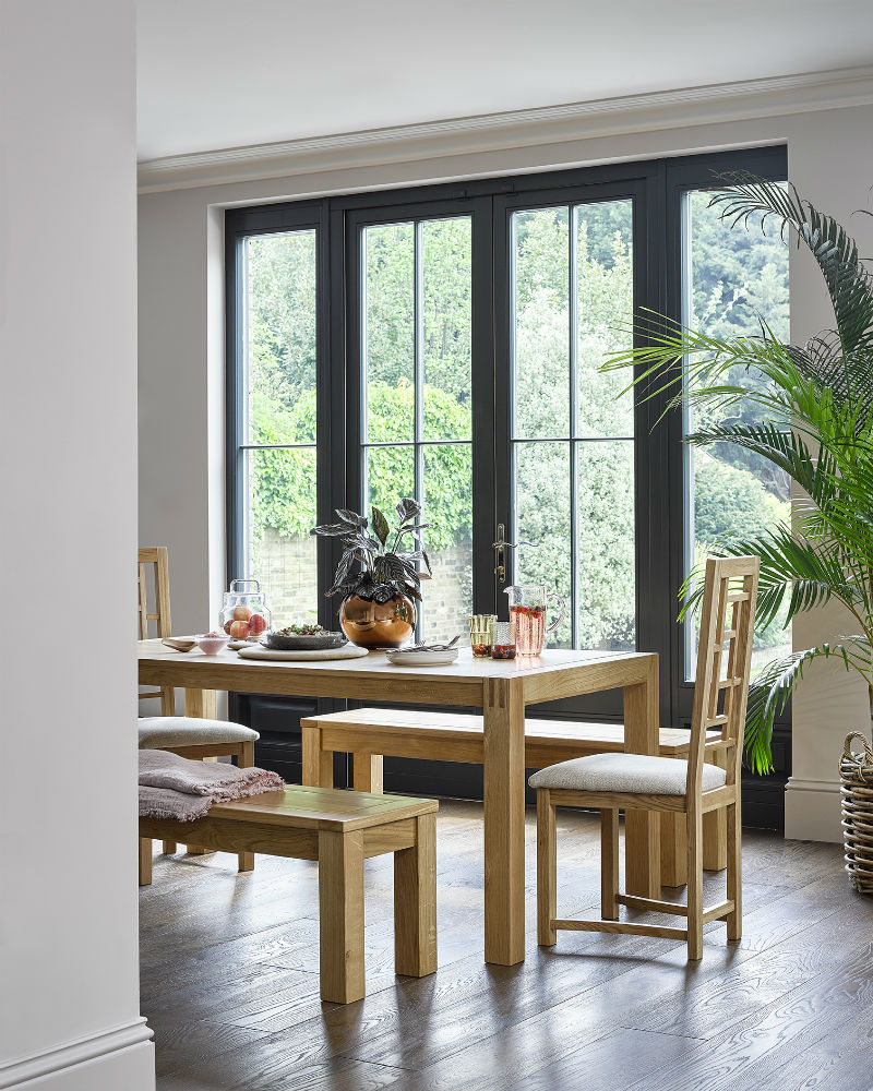 rustic dining table set with bench in bright kitchen