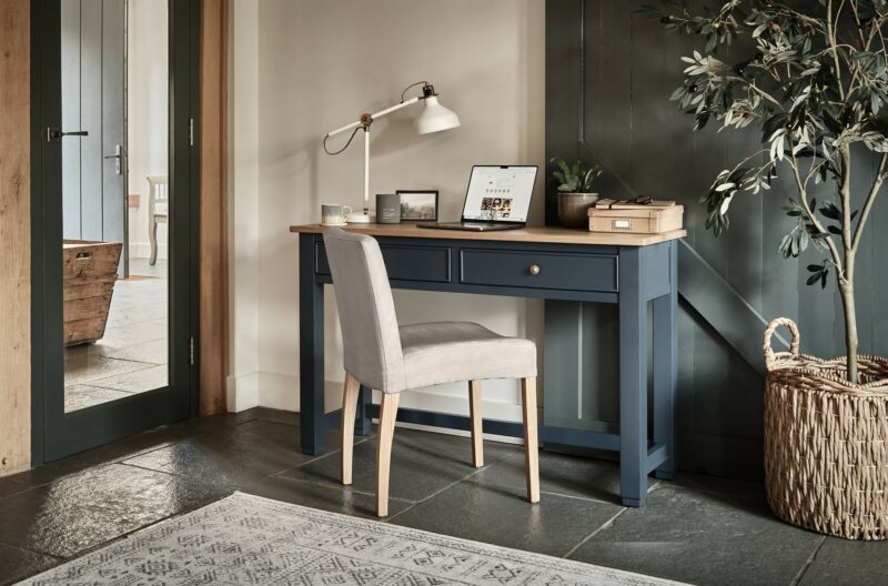 A desk-home office furniture-dark blue desk-wooden table top-olive tree-farmhouse style-beige chair-slate floor-wicker basket