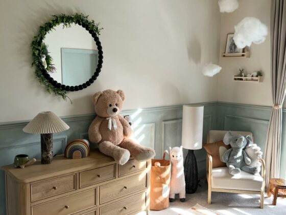 A chest of drawers-nursery furniture-wooden chest of drawers-cuddly toys-patterned rug-panelled walls