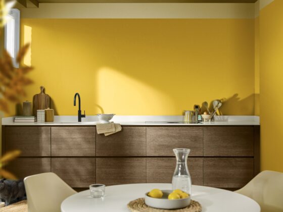 A kitchen and dining table-kitchen diner furniture-yellow walls-wooden kitchen units-yellow accessories