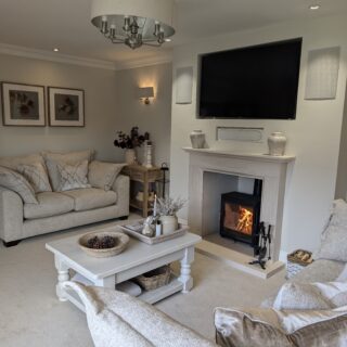 Two sofas, a coffee table and fireplace-living room furniture-cream sofas-painted wooden coffee table-wood burner