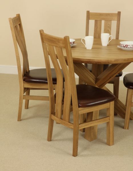 The Solid Oak Round Table with Crossed Legs and Four Arched Back Chairs